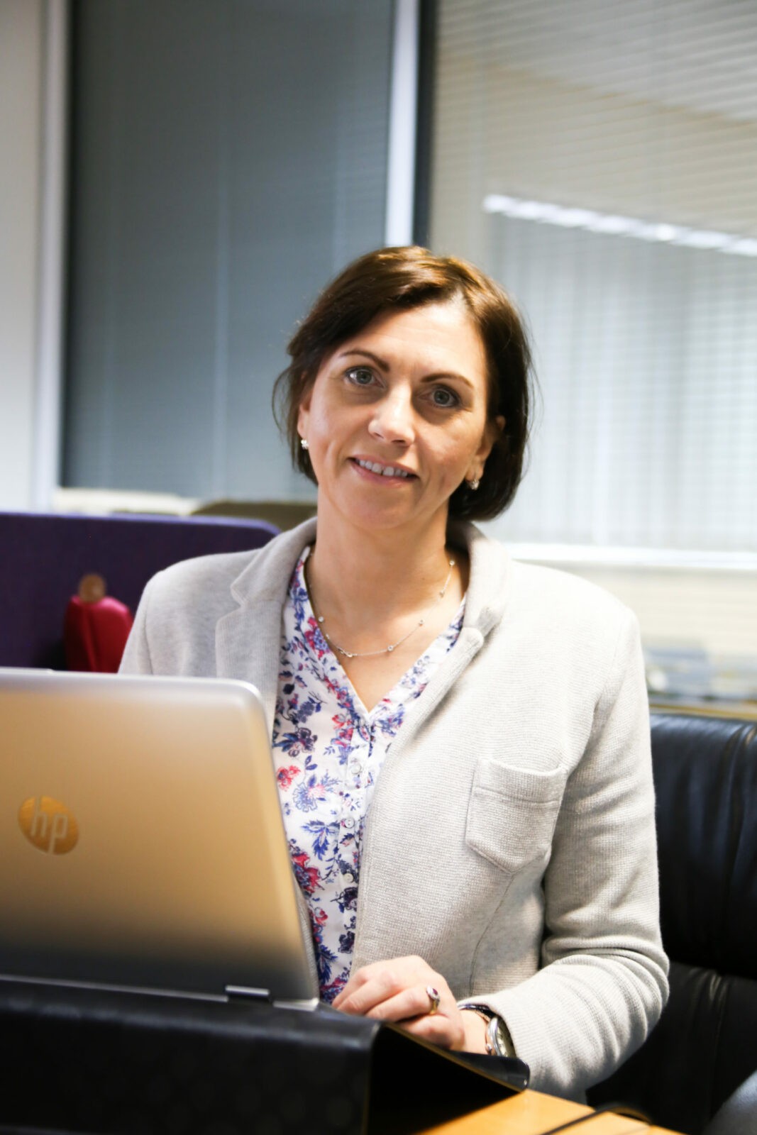 A person sitting at a table using a computer Description generated with very high confidence